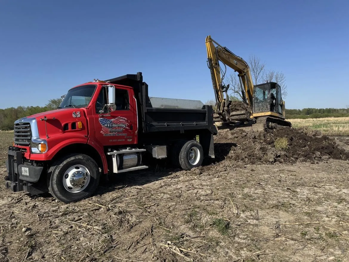 truck hauling excavation equipment