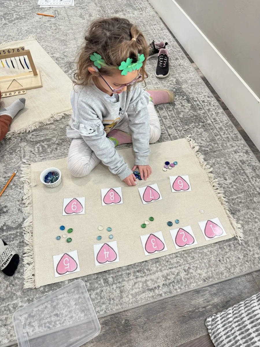 Preschooler counting with Montessori math materials