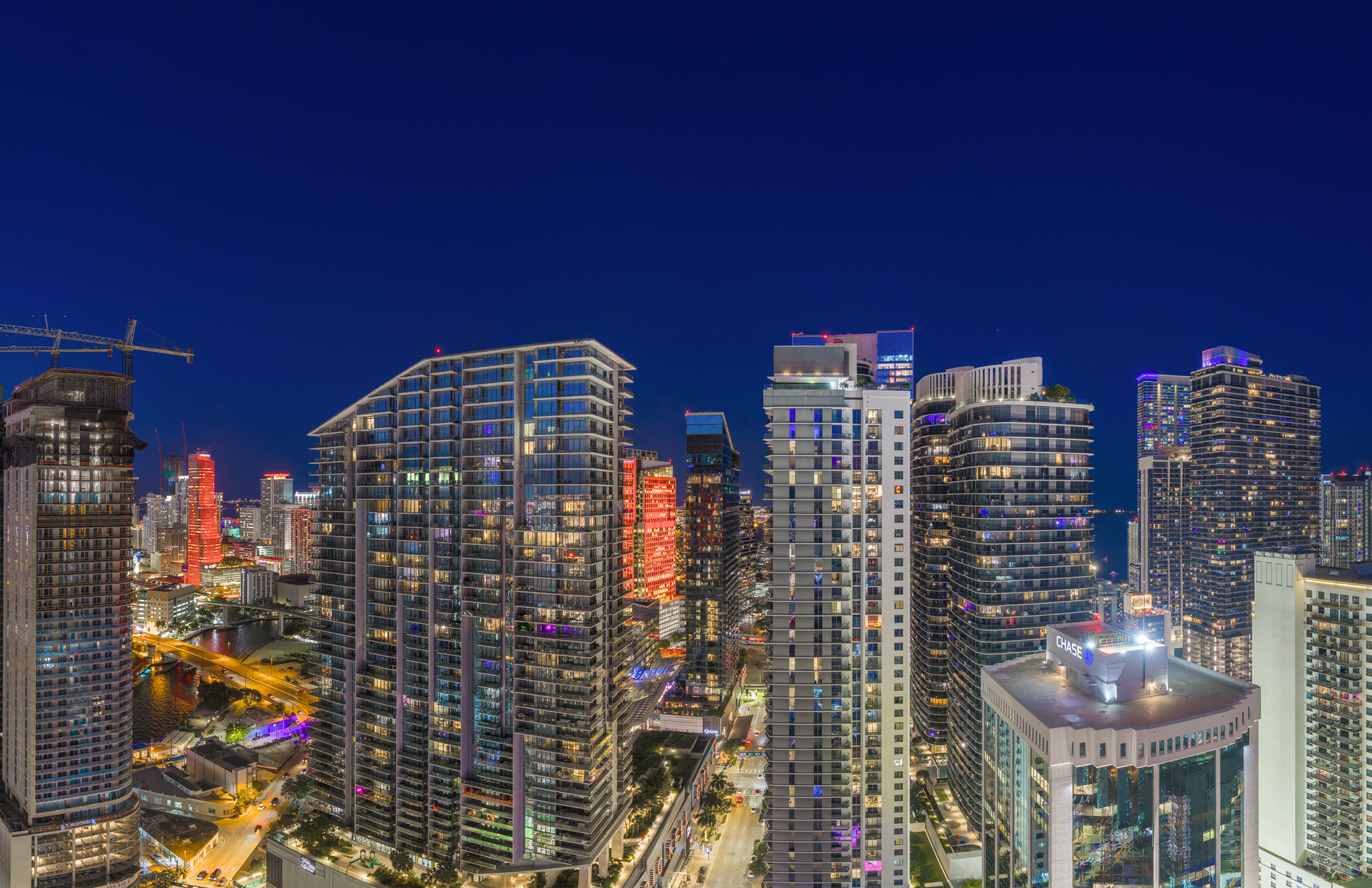 man sitting by the desk using laptop computer