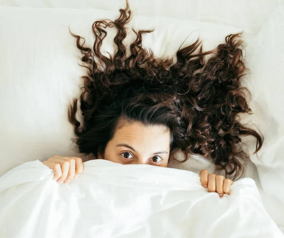 person doing heart shape hand with sun light passing thru