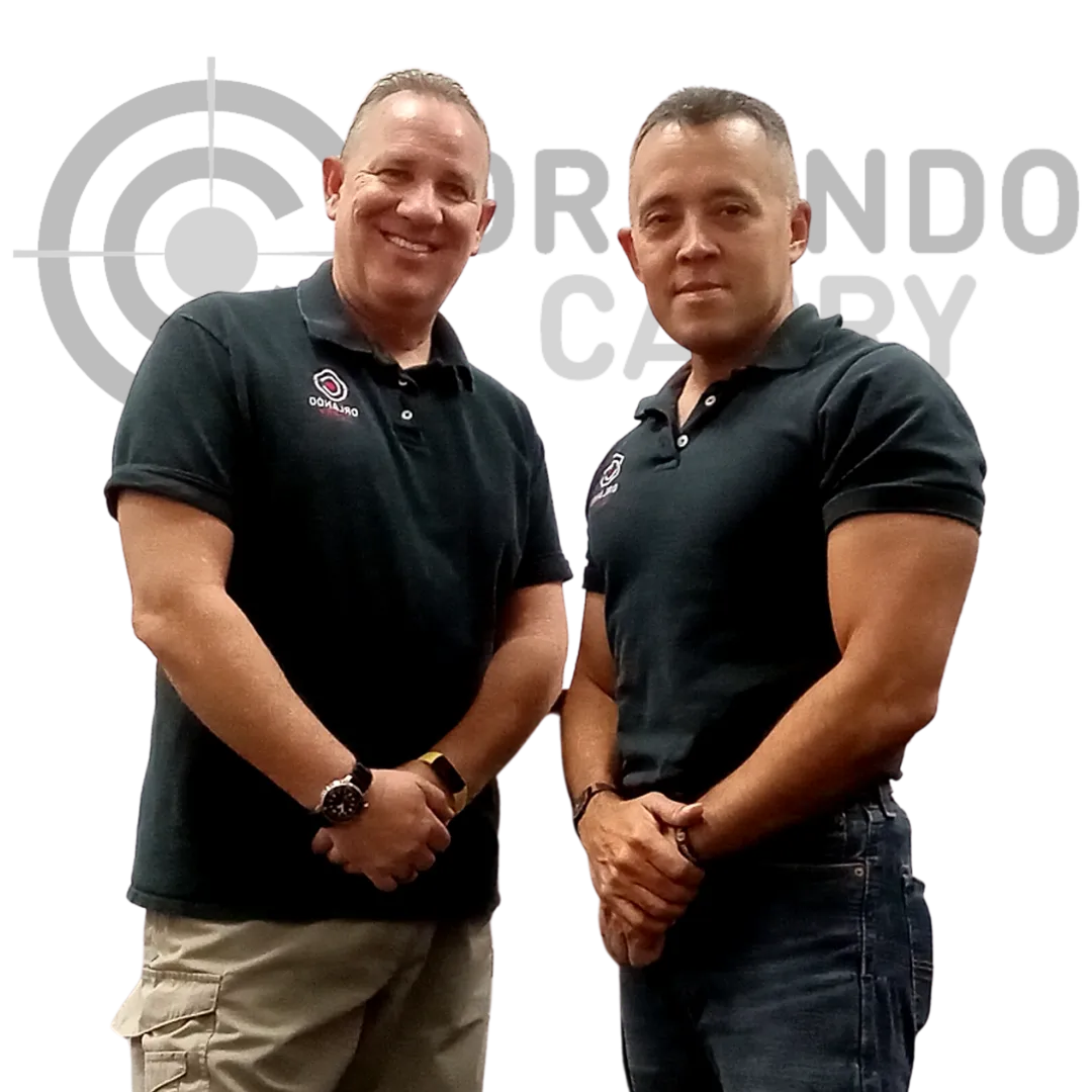 Certified NRA Instructors & Range Safety Officers Craig Schield and Luis Feliciano with Orlando Carry logo in background