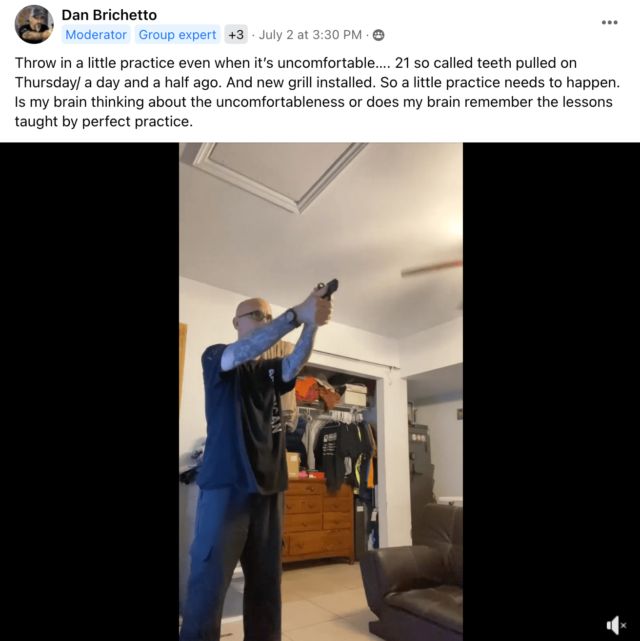 Man practicing proper gun grip and isosceles stance in bedroom