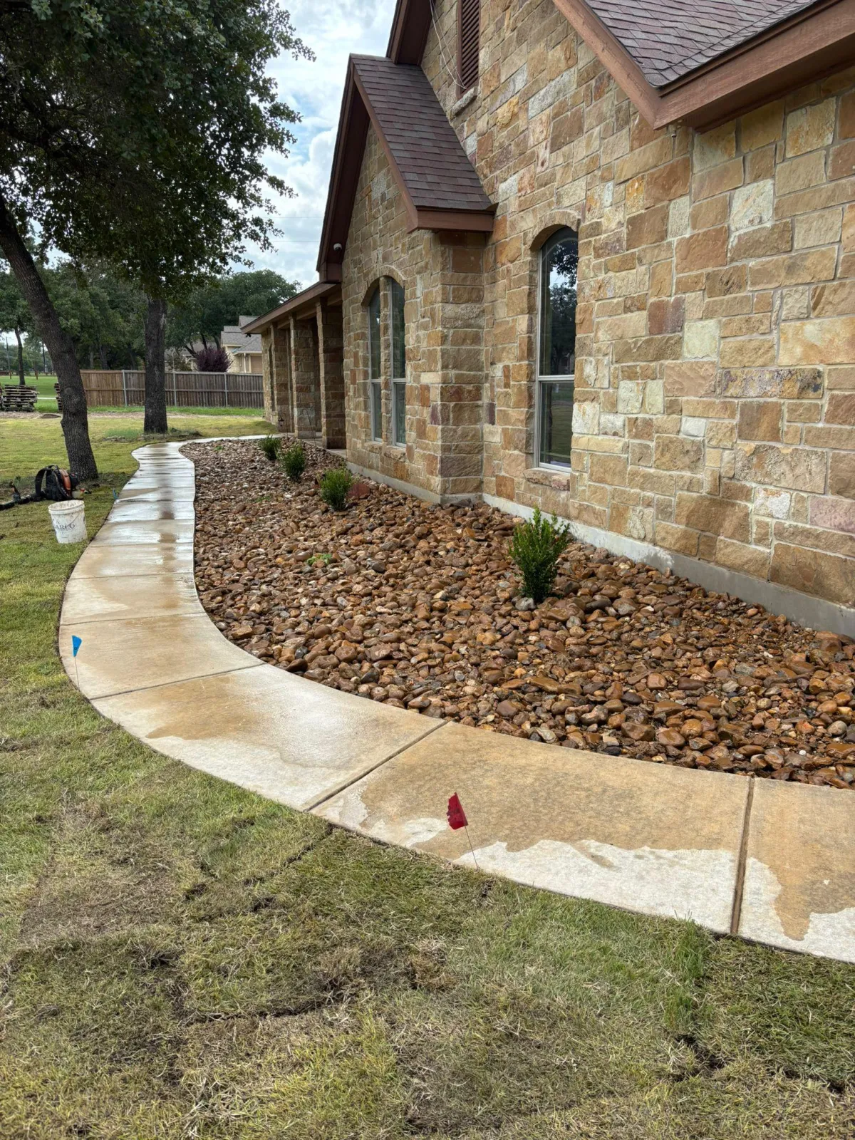 Gardener working in landscaped garden with rocks