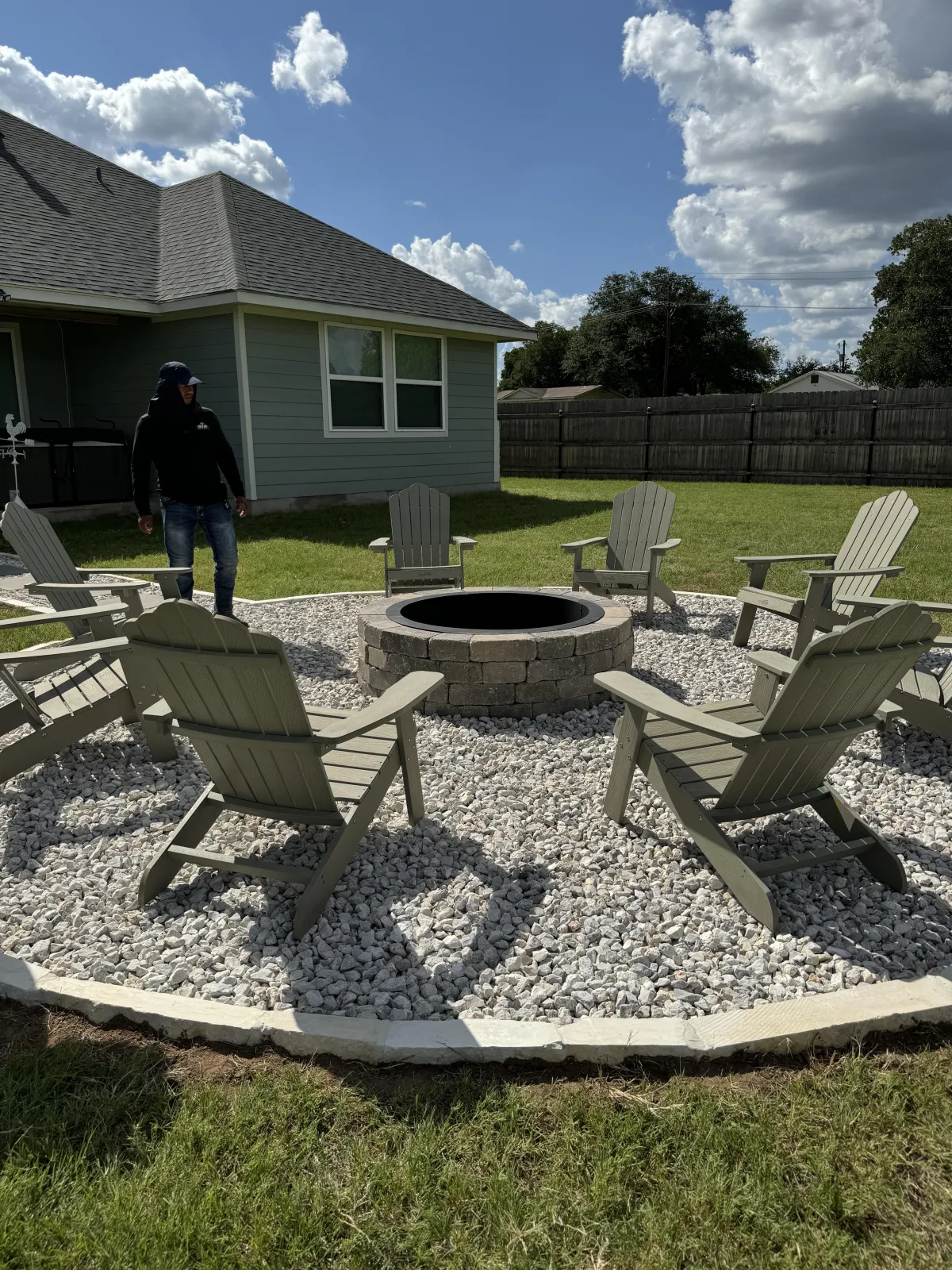 Gardener working in landscaped garden with rocks