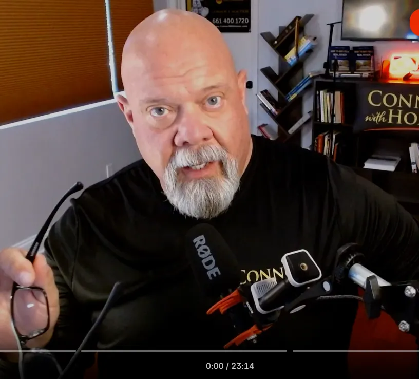 Portrait of Connor, a middle-aged man with a confident smile, wearing a navy suit and LAPD badge pin, standing in front of a Santa Clarita city sign. The background is softly blurred for focus.
