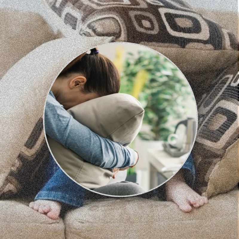 Midlife woman lying face down in a pillow feeling stuck, exhausted and unmotivated