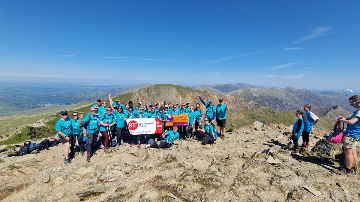 A group of members at Body Transform Fitness Norwich at the top of Snowdon mountain for Charity