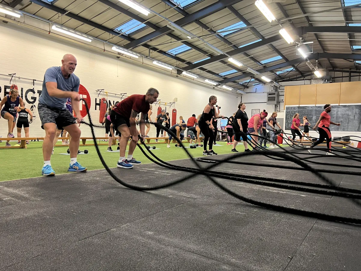 People using battle ropes in a fitness class at Body Transform Fitness Norwich