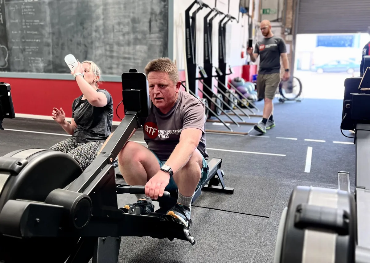 Man on a rower at a fitness class in Body Transform Fitness Norwich