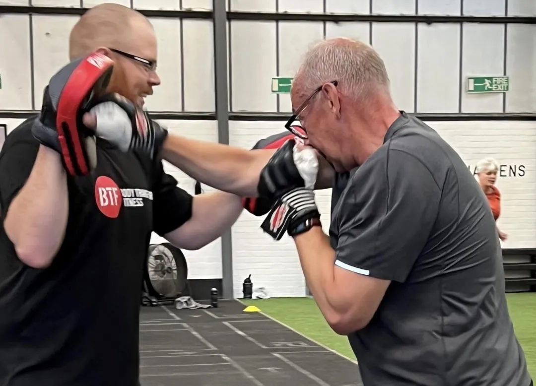 Men boxing in a fitness class at Body Transform Fitness Norwich