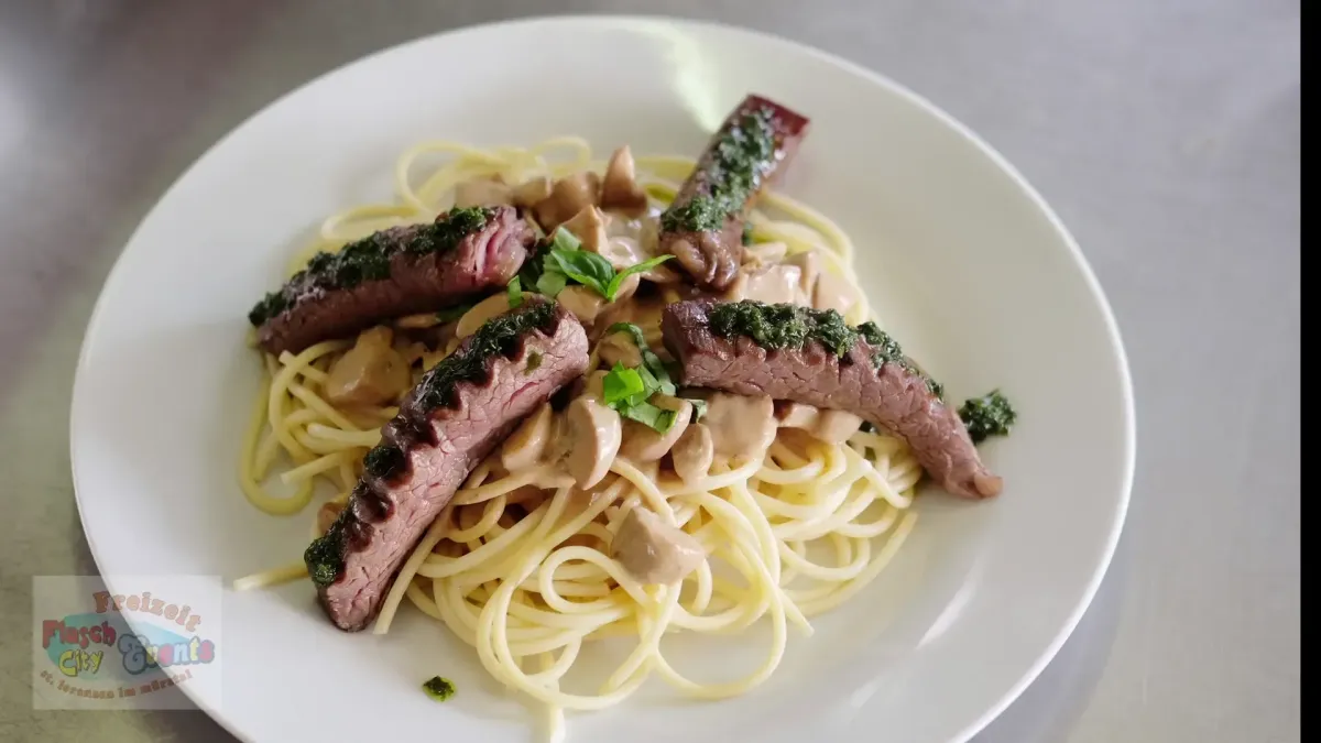 Geschnittenes medium-rare Steak auf Spaghetti mit Pilzrahmsauce im Flasch City steak restaurant-cafe near obersteiermark