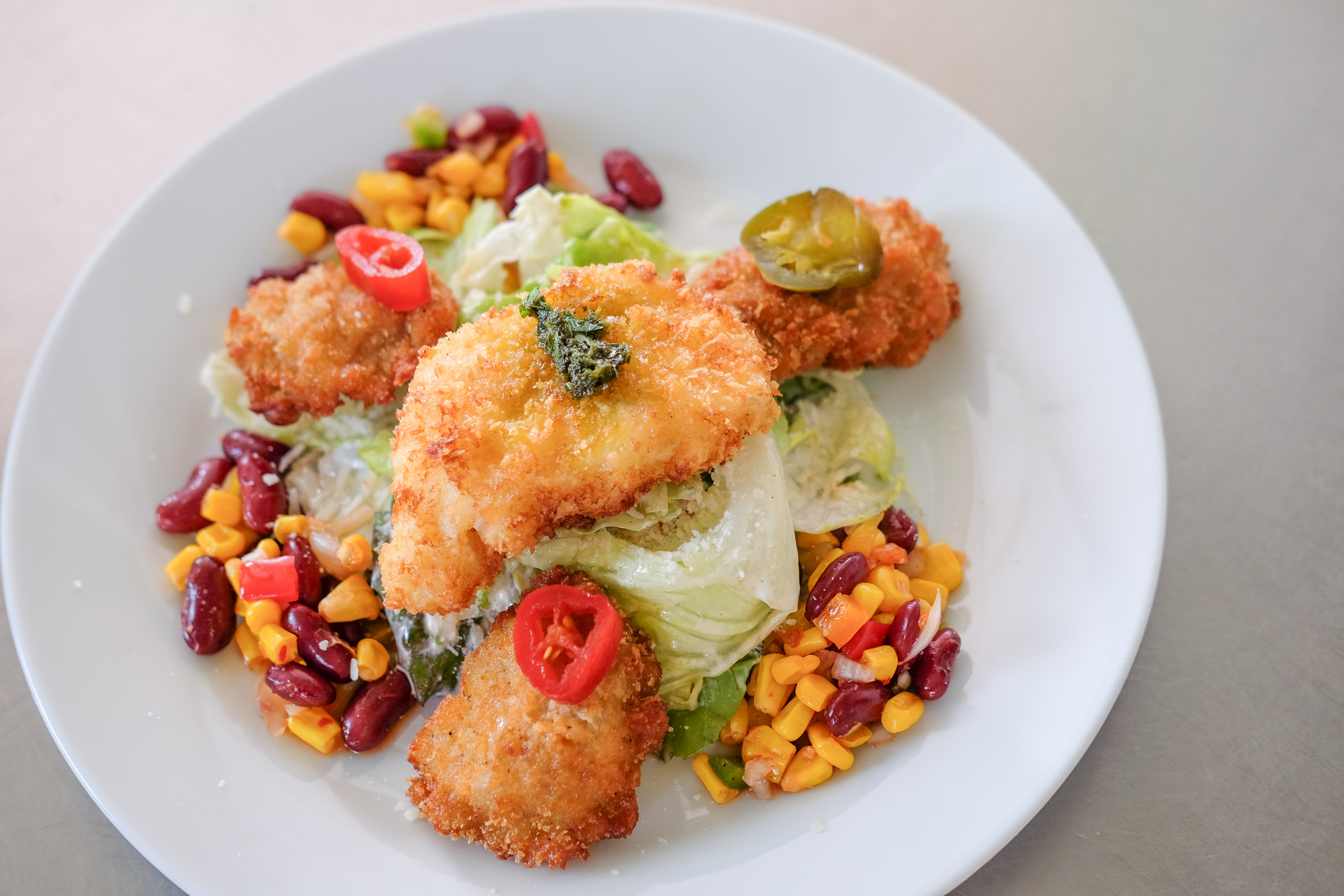 Gebackenes Fischfilet auf frischem Salat mit Bohnen und Mais im meeresfrüchte & forelle restaurant-cafe in Flasch City near Steiermark