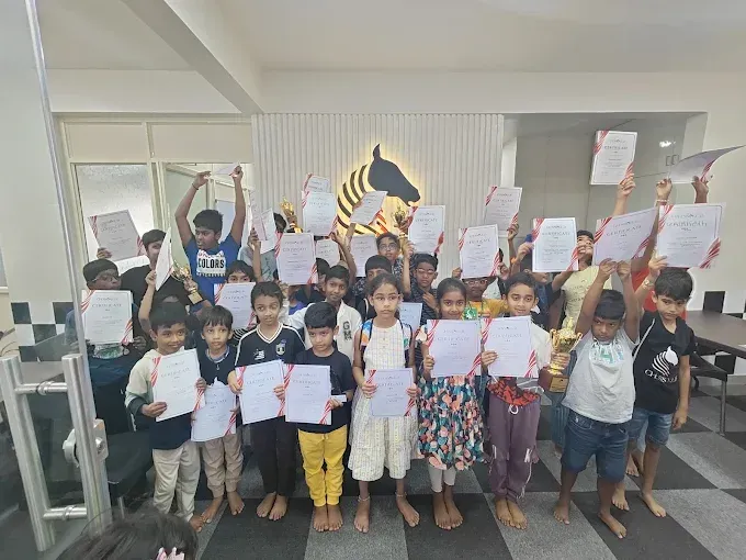 Students at CHESS KLUB with certificate on a Stage