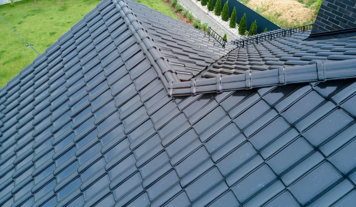 Modern roof design with sleek tiles installed in Western NH by Olsen’s Roofing.