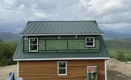 Standing seam metal roof installation on band new home by Olsen's roofing