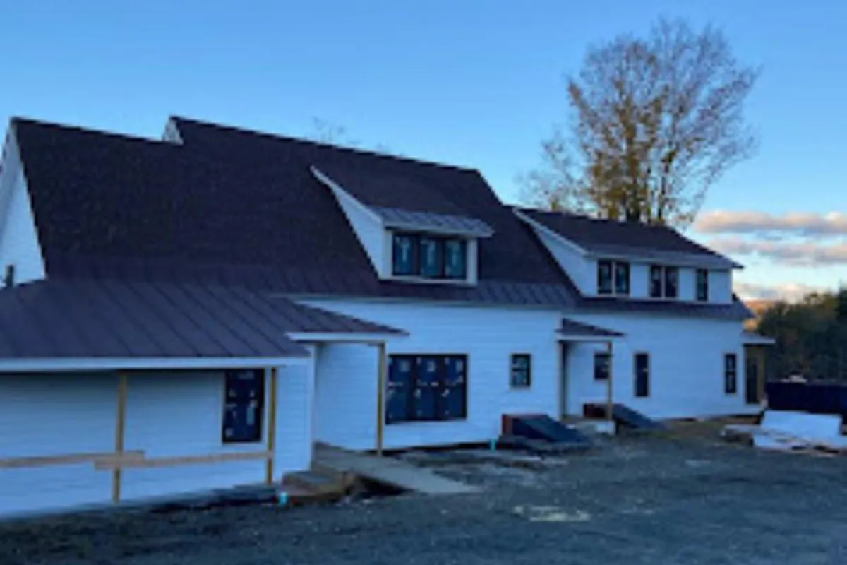 Modern roof design with sleek tiles installed in Western NH by Olsen’s Roofing.