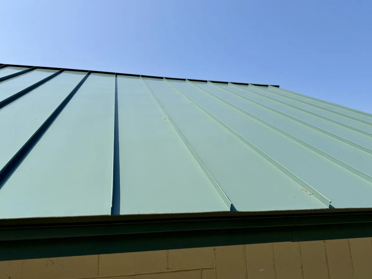 Green standing seam metal roofing job done by olsen's roofing