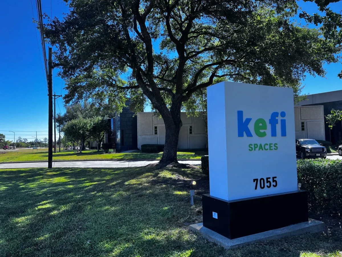 Outdoor sign for kefi SPACES with building number 7055.   