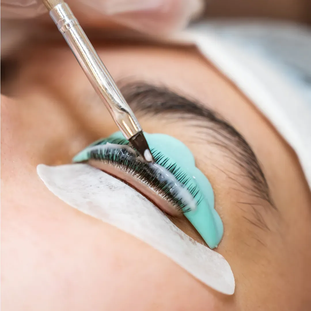 Close-up of a professional brow tint application with tinting solution brushed onto the eyebrows at Soul Serenity