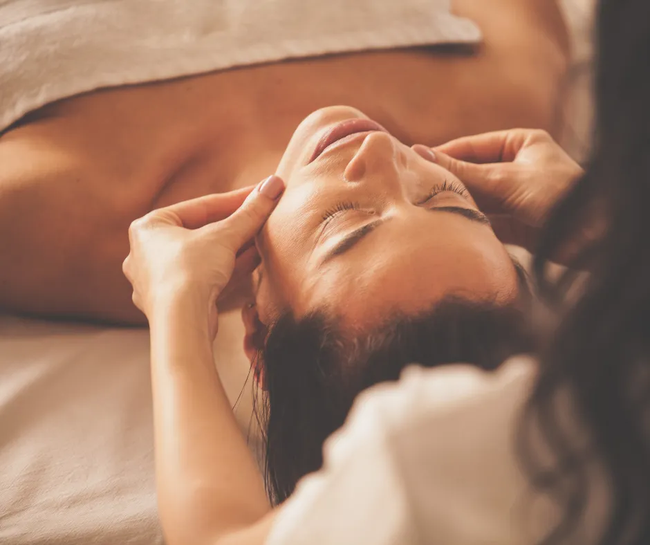 Holistic skincare treatment room at Soul Serenity Beauty & Wellness in Newburyport MA, featuring a massage table, NeoGen PSR device, warm lighting, and a calming, spa-like atmosphere.