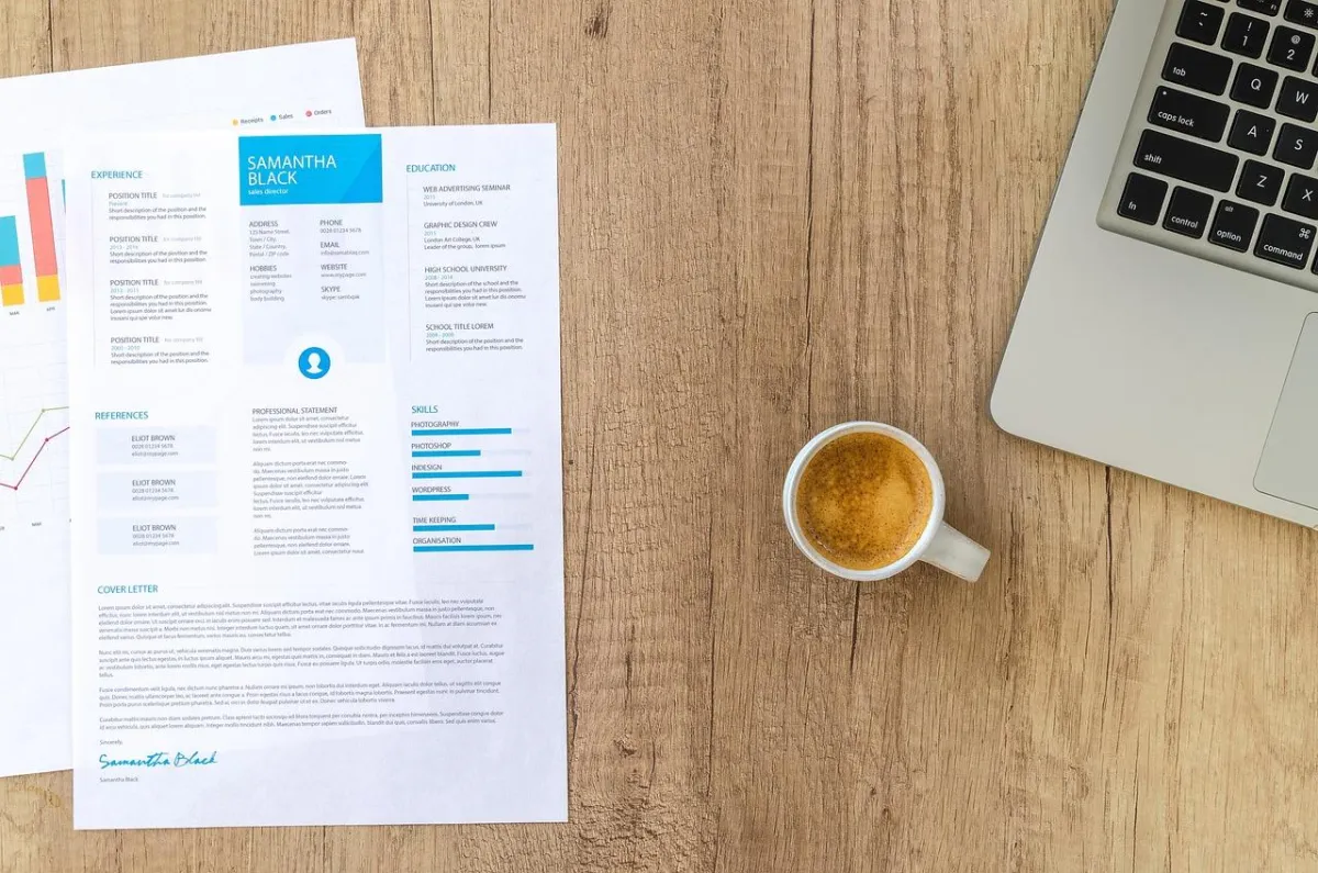 image of a professional CV with a mug and a laptop