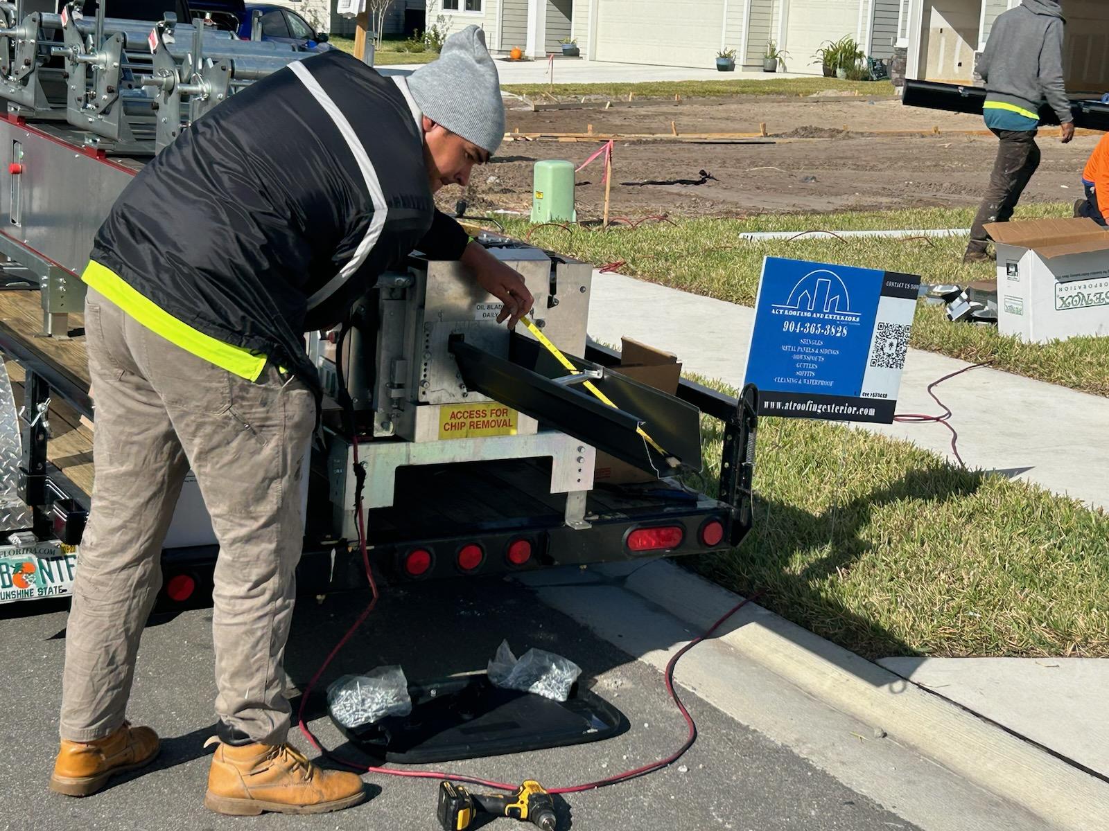 Local roofing foreman utilizing Jacksonville custom metal roofing fabrication on a complex roofline