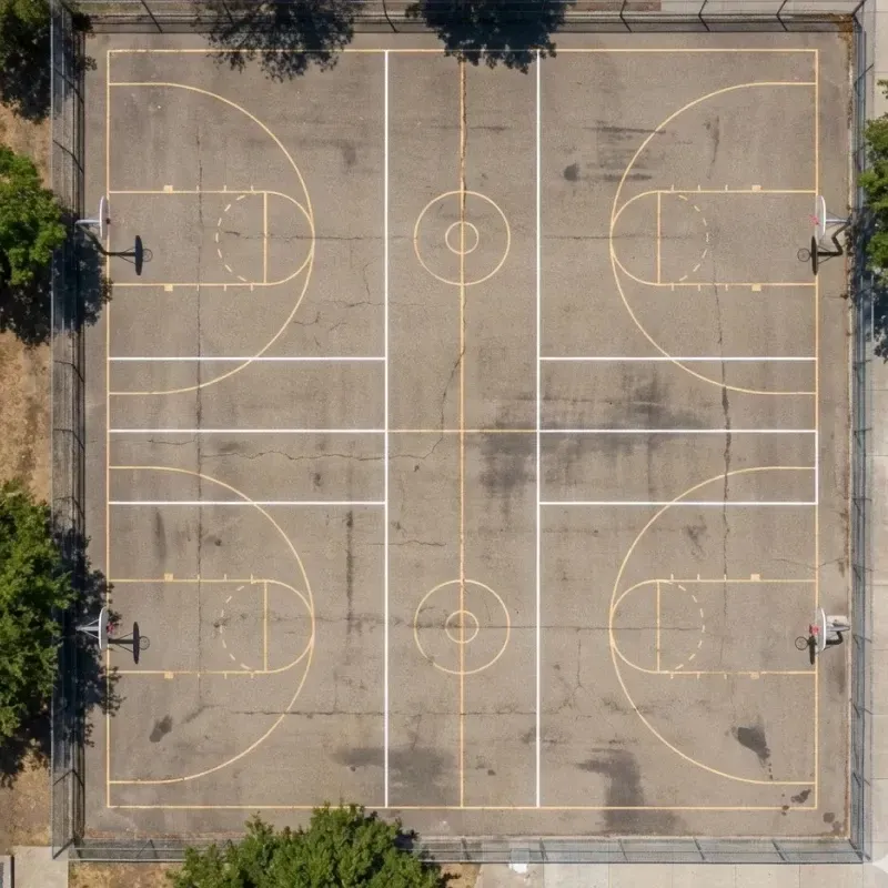 image of a drone shot on a basketball court that has pickleball lines