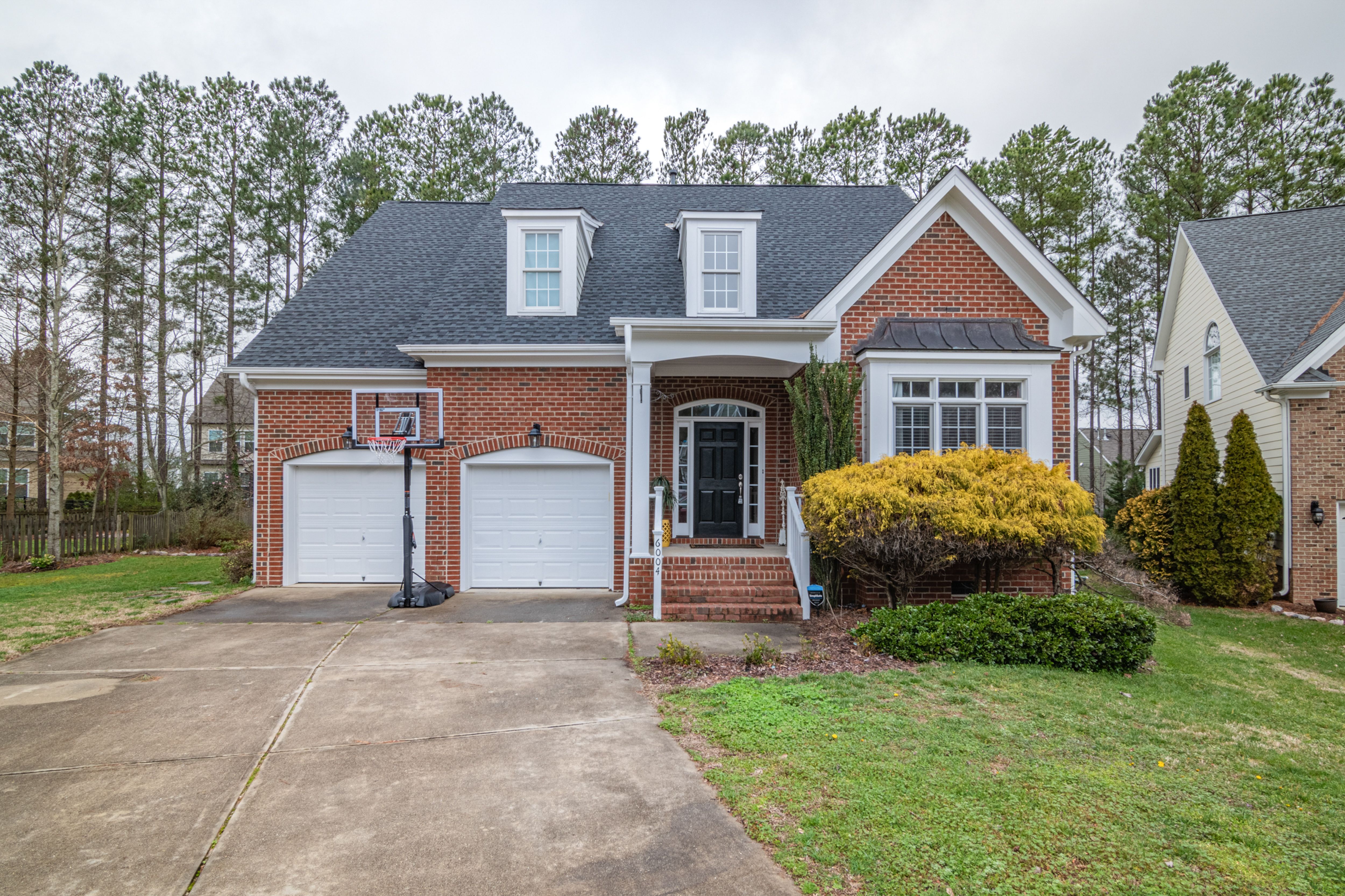 Kings Grant Virginia Beach brick home on a wooded lot near the neighborhood lakes