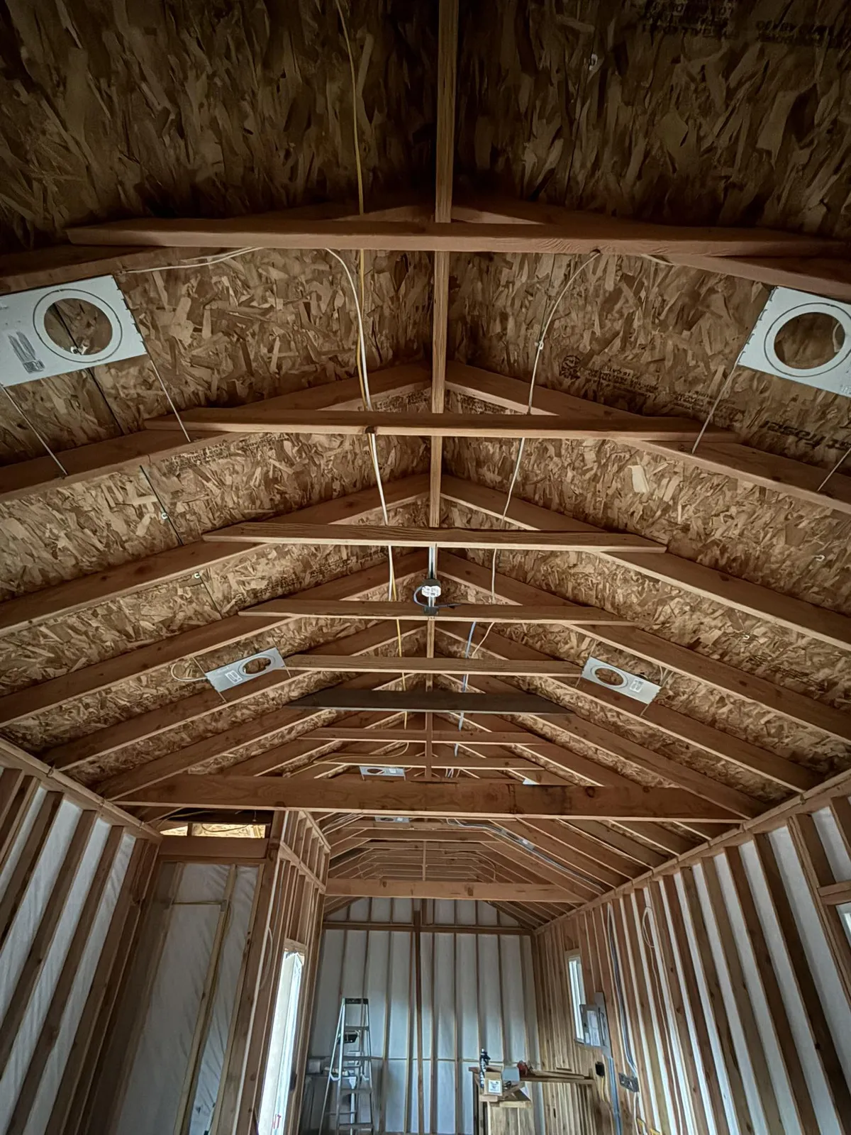Rough-in wiring and recessed light boxes in a framed outbuilding ceiling