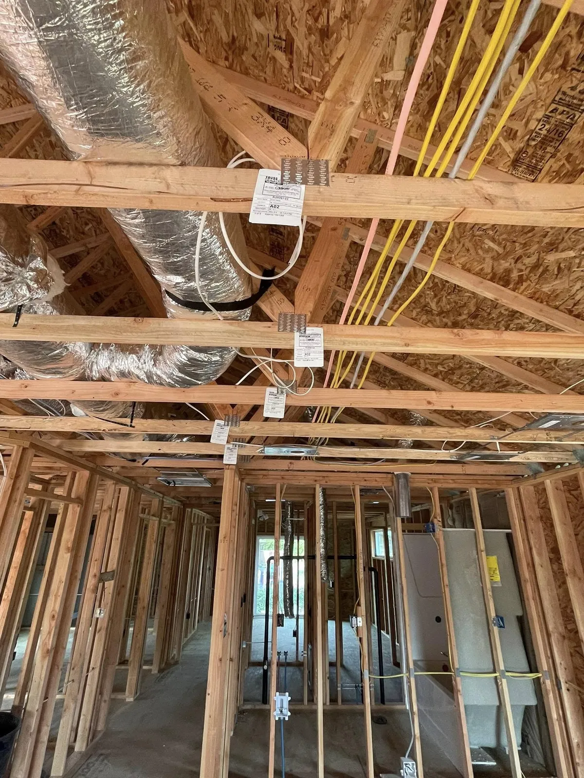 Rough-in electrical wiring, junction boxes and ductwork in a framed new-construction ceiling