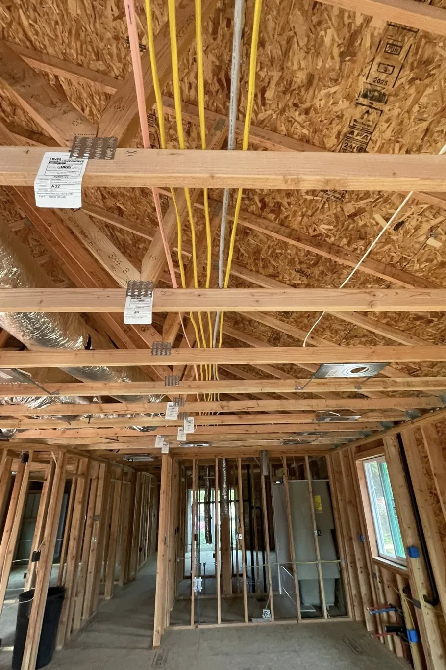 Rough-in electrical wiring and junction boxes in a framed new-construction ceiling