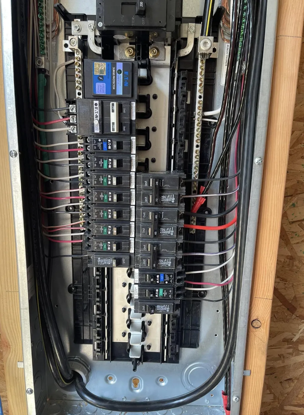 Interior of a residential electrical panel with breakers and neatly run wiring