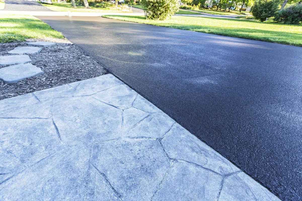 Black Hawk Paving residential driveway paving with smooth asphalt finish and stone edging