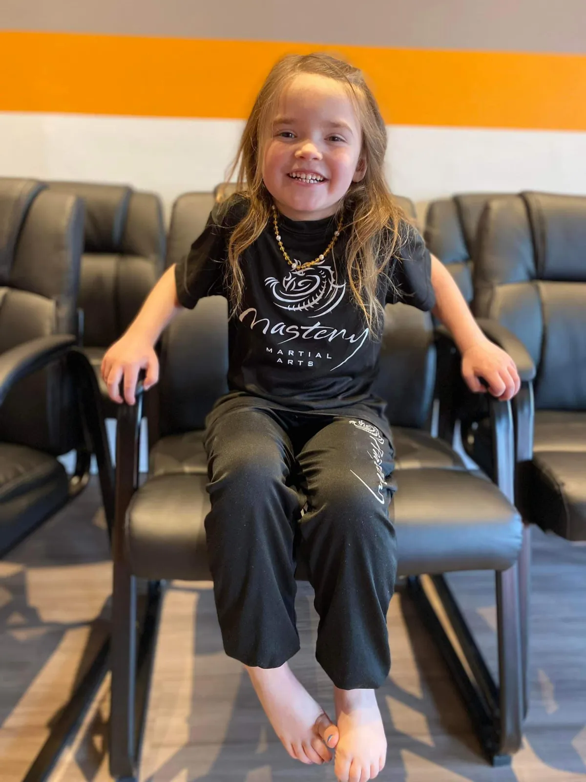 kids martial arts troy - girl sitting in chair