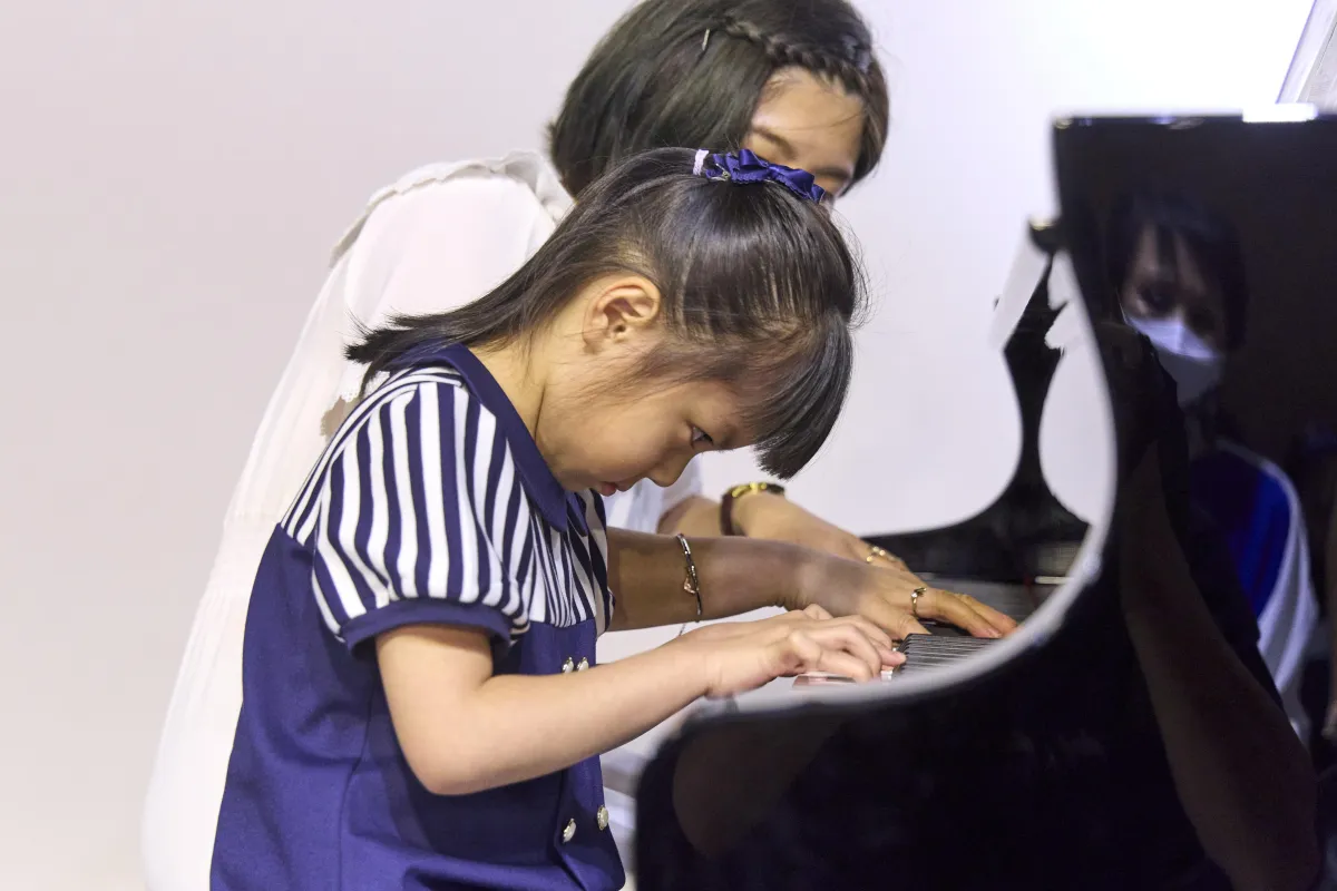 Girl getting piano lessons