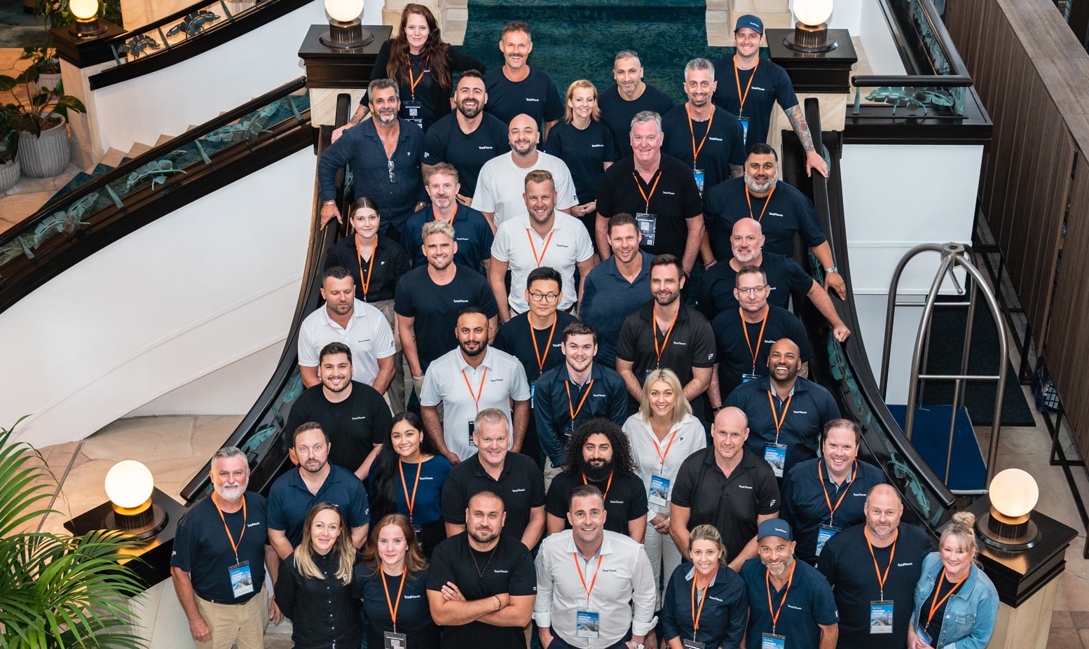 Confident franchise owner in branded workwear, standing on a modern fitout site, sunlight streaming through windows, tools in hand, Australian urban setting, 3:2 aspect ratio