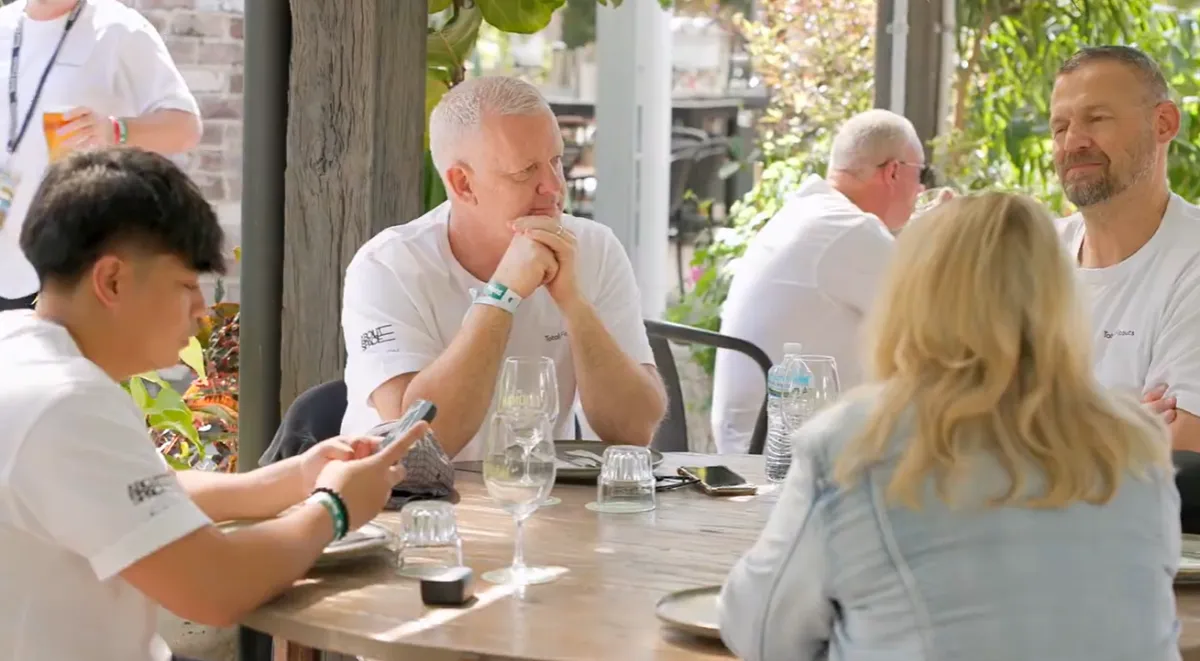 Franchise owner with family, backyard BBQ, relaxed, smiling, Australian home, 3:2 aspect ratio