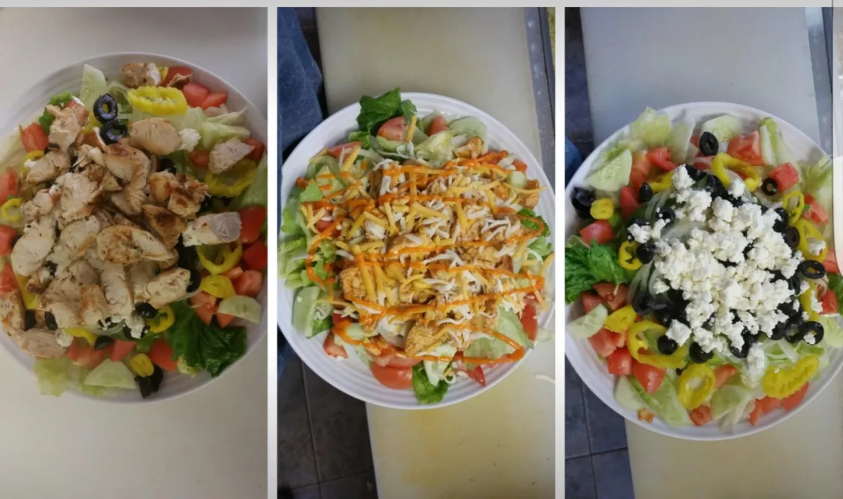 a sandwich with lettuce and meat on a wooden surface