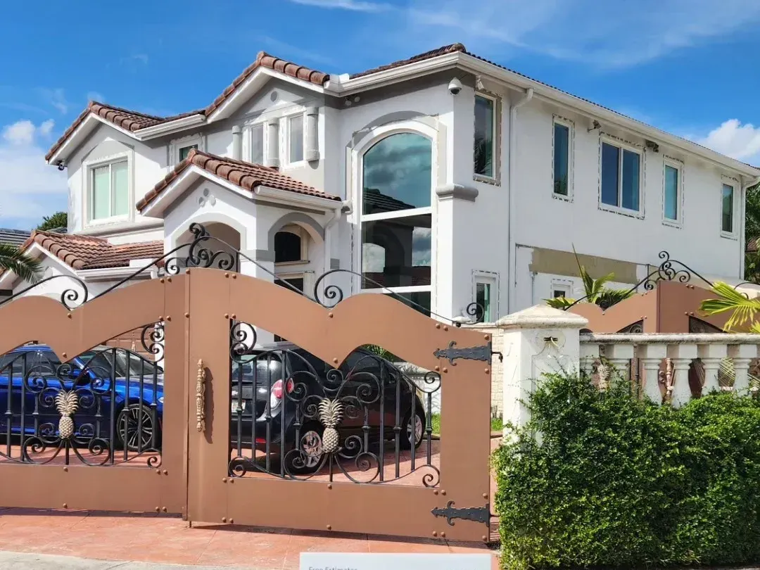 Impact window installation in Kendall Florida showcasing sleek design, clear glass, and vibrant tropical landscaping.