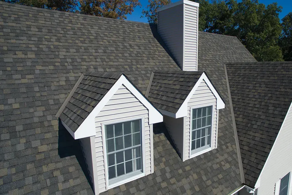 a beautiful shingle roofing with white windows