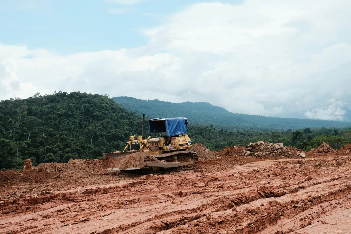 Tracked bulldozer working across a rough-graded earthwork site.