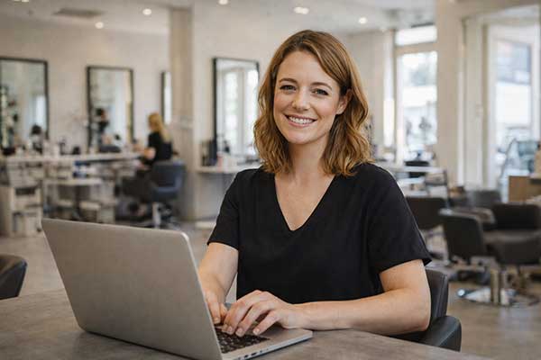 Salon owner setting up automated appointment reminders and booking automation for their business