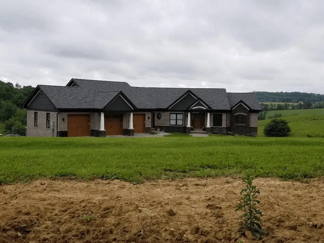 Recently remodeled kitchen in Canonsburg PA featuring modern wood cabinetry, stainless steel appliances, and elegant granite countertops.