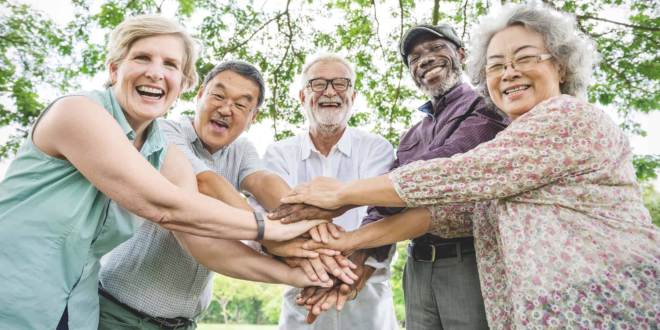 Older men and women enjoying coffee together at EverHeart Senior Living
