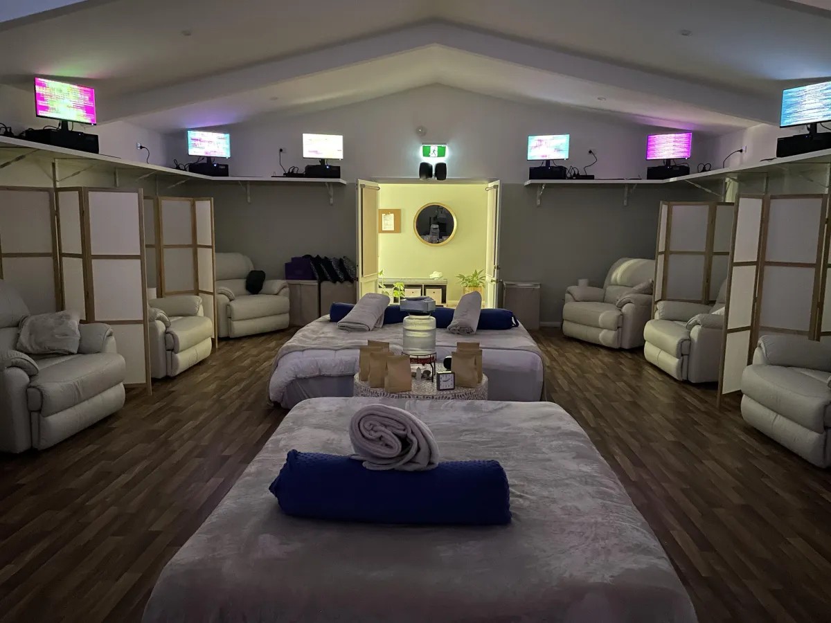 Energy Enhancement System lounge at EE Wellness Within in Mildura with comfortable recliners, massage tables, and scalar wave technology screens