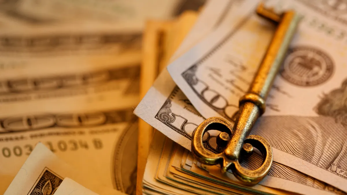 Stack of dollar bills and coins representing financial wealth