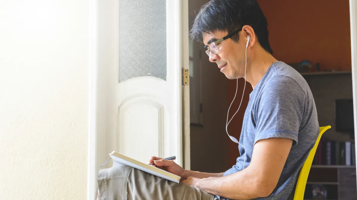 Person writing a gratitude list in a journal, building mental strength through daily reflection.