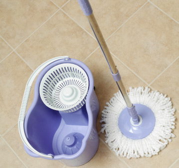 Woman with headphones cleaning a shelf