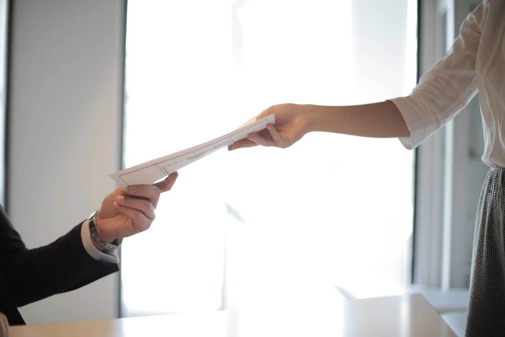 Person handing in a CV to an employer