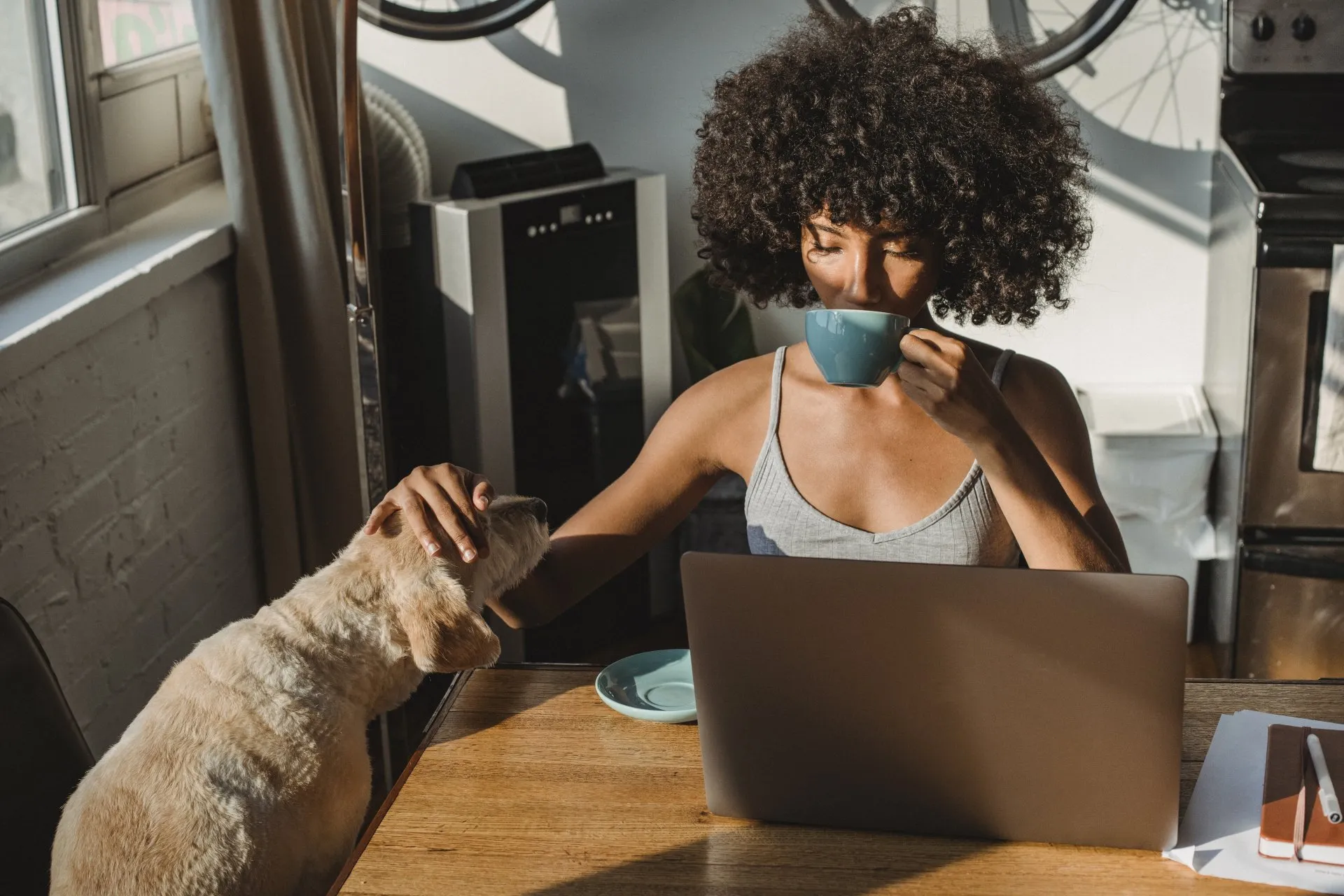 Woman working on laptop at home with a coffee